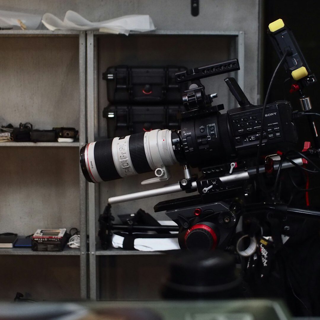 Belgian video journalist holding a professional camera on a news set